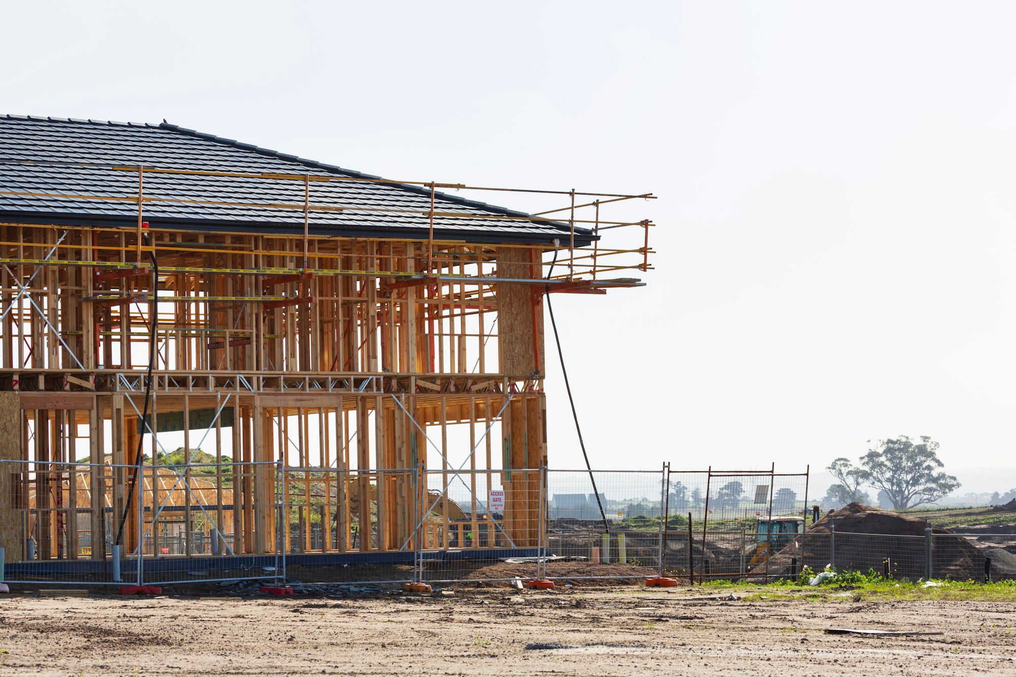 A house under construction wrapped in scaffolding