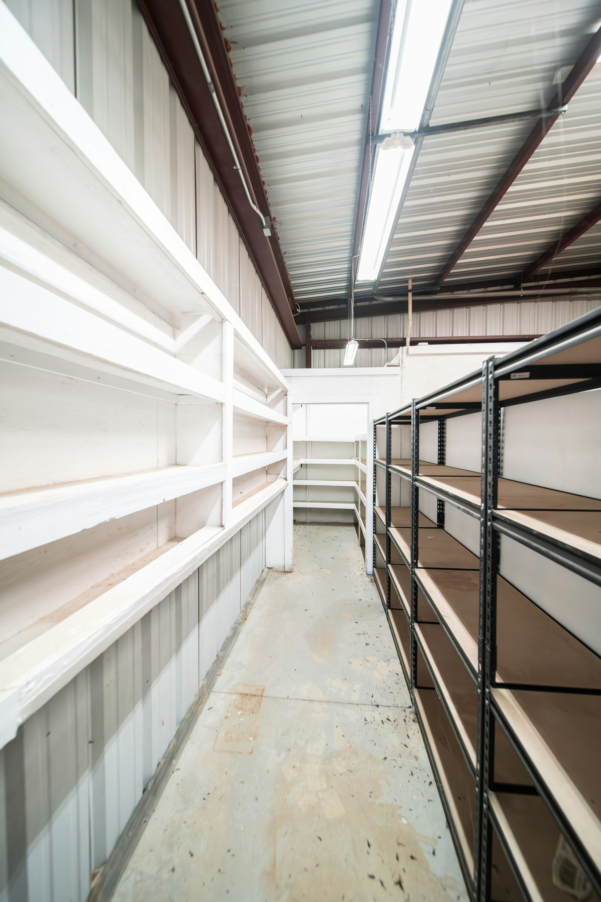 A long row of stocked shelving inside a distribution warehouse